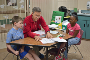 John Kidd and children in Reading Corps