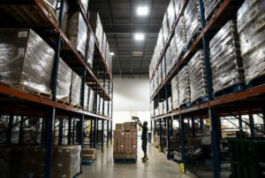 Person stacking boxes at Second Harvest Heartland. Photo credit: Renee Jones Schneider