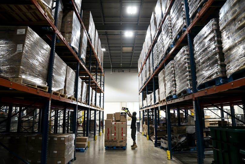 Person stacking boxes at Second Harvest Heartland. Photo credit: Renee Jones Schneider